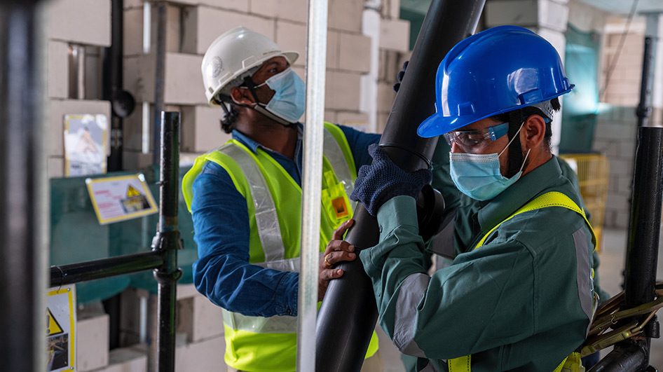 Technicians bring another stack into place.