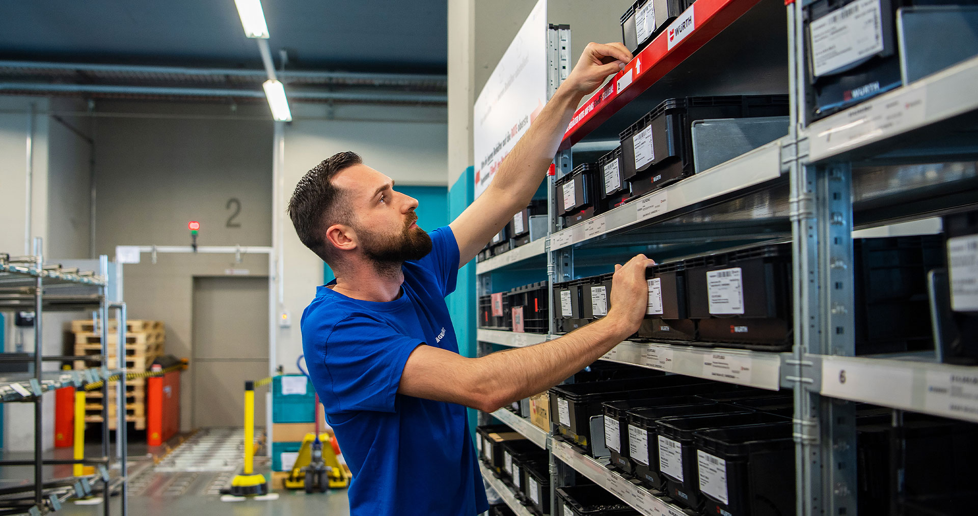 An employee searching an intelligent shelf in a warehouse