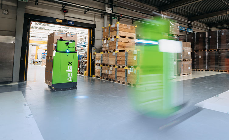 Two driverless transport systems going around a warehouse 