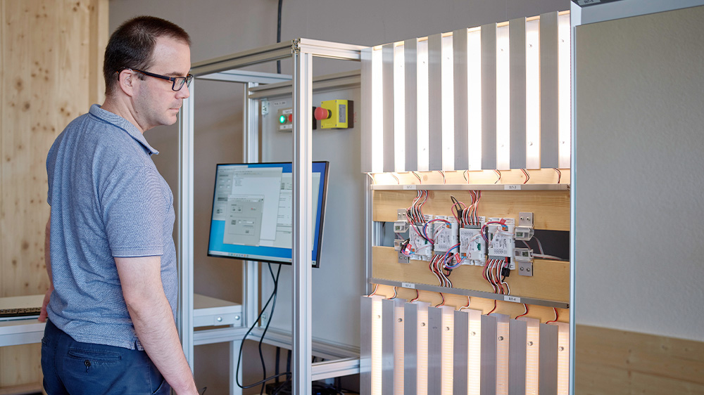 Jörg Naef at a test facility for the ComfortLight control on mirror cabinets