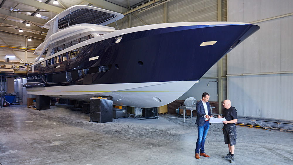 Arjan Schevers from Geberit in front of the yacht in the shipyard
