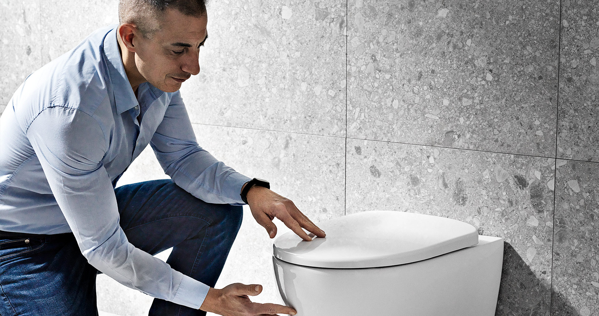 Product manager Fabio Peyla inspecting a new toilet model for Geberit