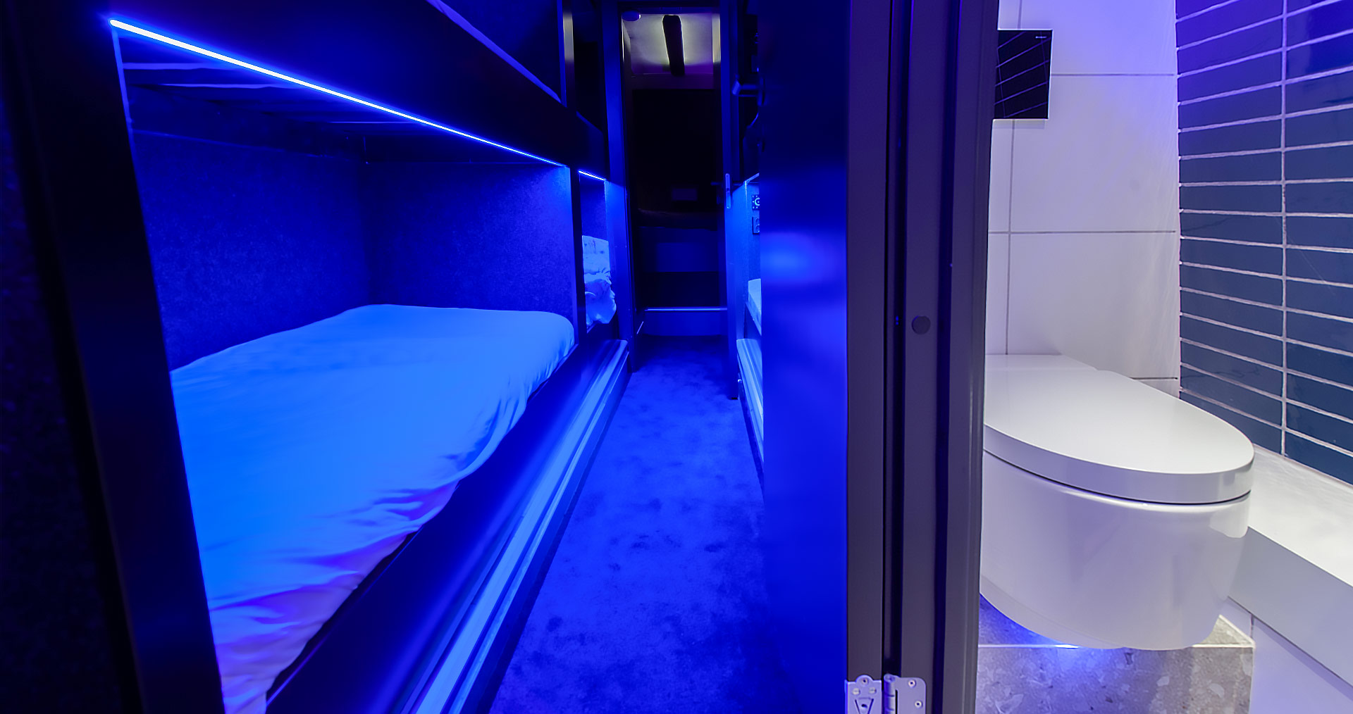 Geberit shower toilet in a modern bathroom illuminated with blue light, setting unconventional comfort standards