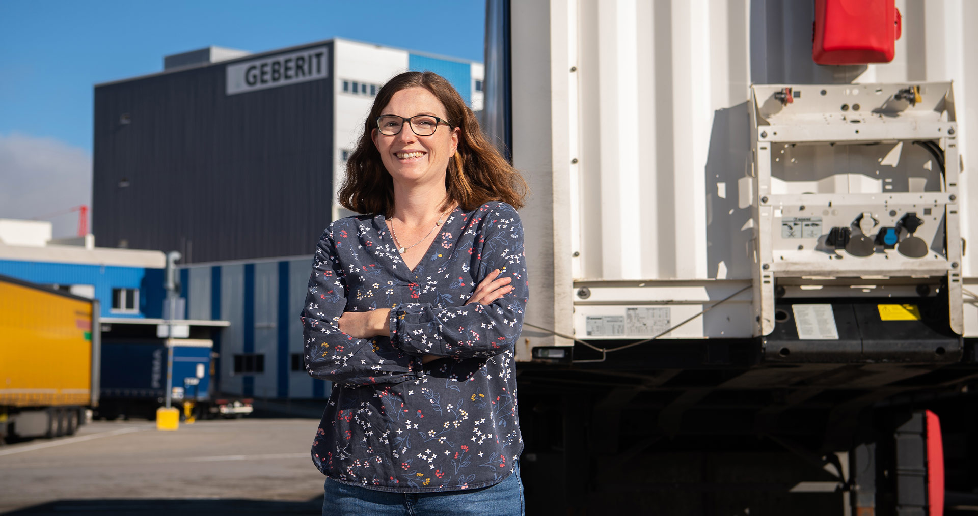 Julia Dreher, Head of Group Logistics, standing in front of the Geberit logistics center in Pfullendorf