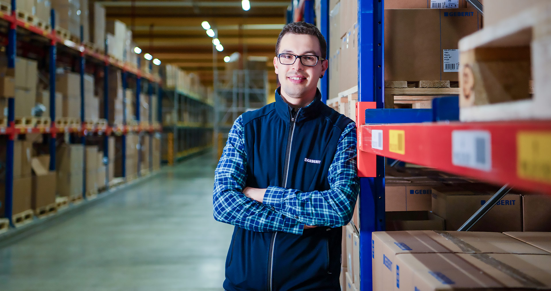 Stefan Matheis, Global Business Process Manager at Geberit, standing confidently in the warehouse
