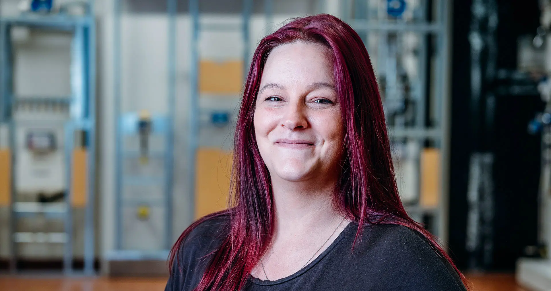 Sarah Berner, production master at Geberit in Pottenbrunn, smiling in the factory