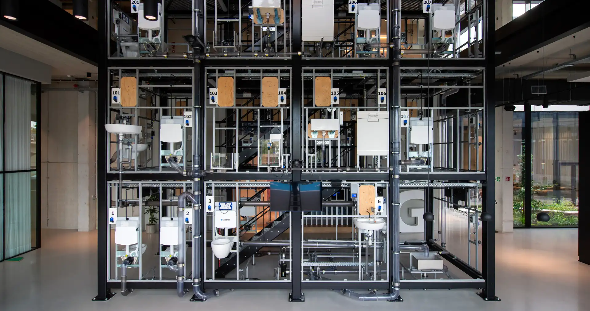 View of a vertical display area featuring various bathroom models within a modern building