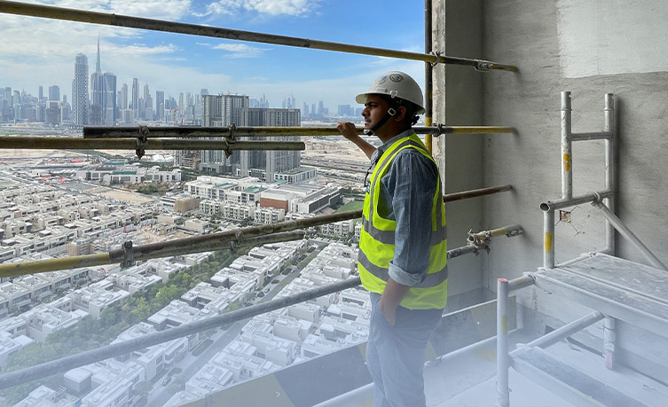 Labourer named Vineet Kumar Bhaskar on a high-rise scaffolding with a city view