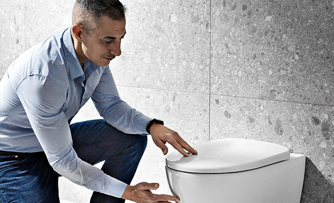 Product Manager Fabio Peyla inspecting a new toilet model for Geberit