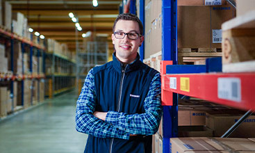 Stefan Matheis, Global Business Process Manager at Geberit, stands confidently in the warehouse