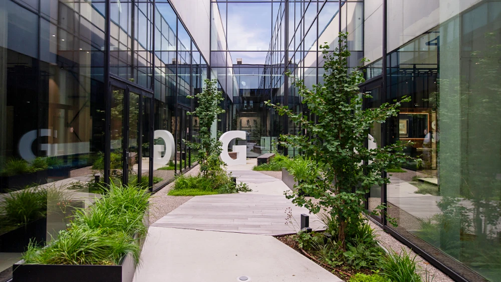 From the cafeteria, the view falls onto the green inner courtyard that divides the building