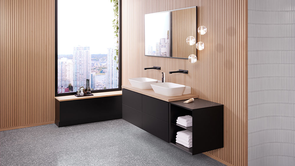 Geberit's matte black washbasin furniture paired with wood for a striking bathroom accent