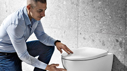 Product Manager Fabio Peyla inspecting a new toilet model for Geberit