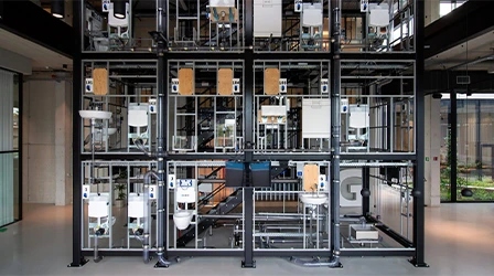 View of a vertical exhibition area with various bathroom models in a modern building