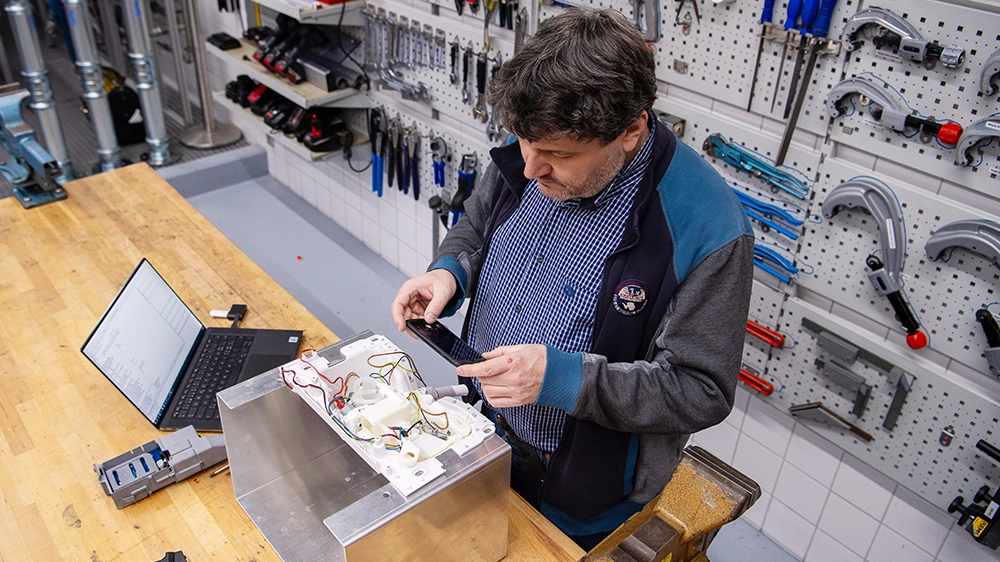 A development engineer at work: Andrea Bühlmann inspects the electronic components.