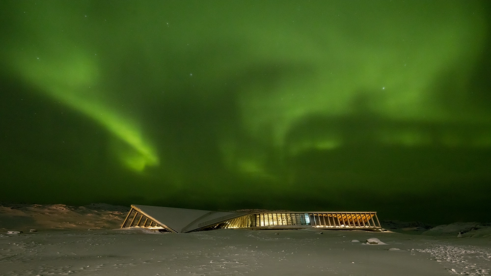 The Icefjord Centre against the backdrop of the Northern Lights.