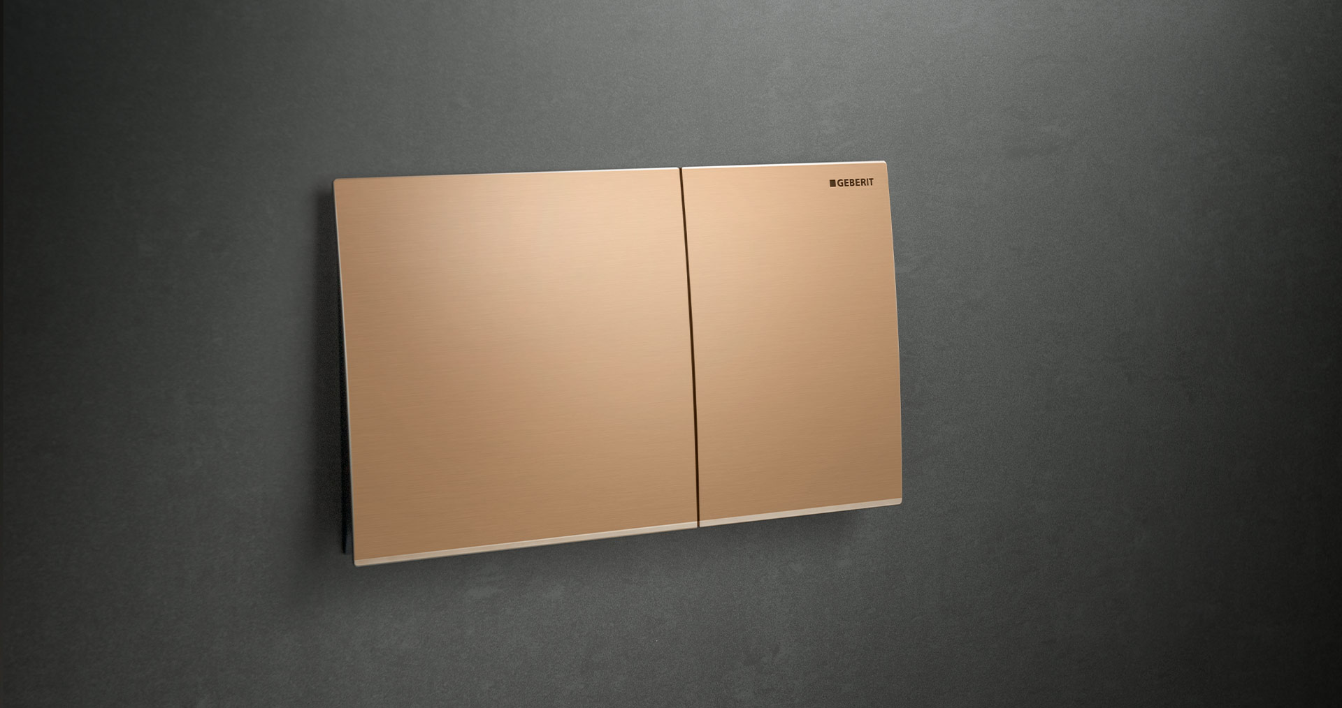 Betätigungsplatte für WC-Spülung von Geberit, Modell Sigma70, in rahmenlosem Design und bronzefarben, anscheinend schwebend montiert auf dunklem Hintergrund